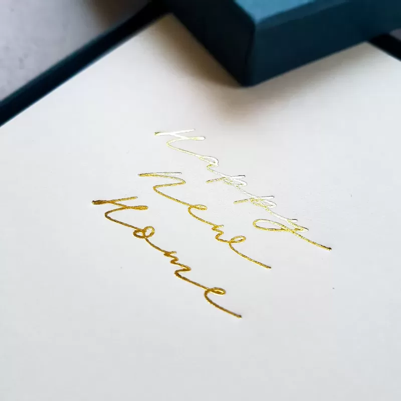 Cream card with Happy New Home text foil blocked on the front