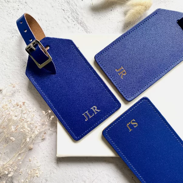 Blue luggage tags with personalised initials and adjustable straps